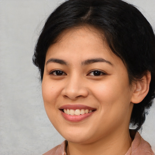 Joyful asian young-adult female with medium  black hair and brown eyes
