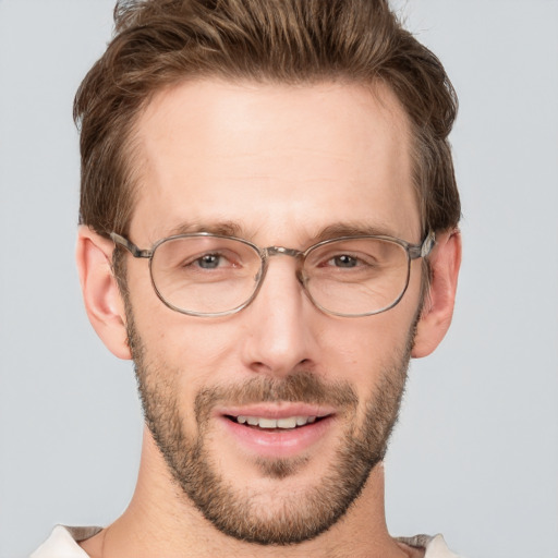 Joyful white adult male with short  brown hair and grey eyes