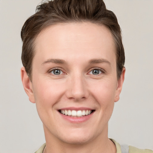 Joyful white young-adult female with short  brown hair and grey eyes