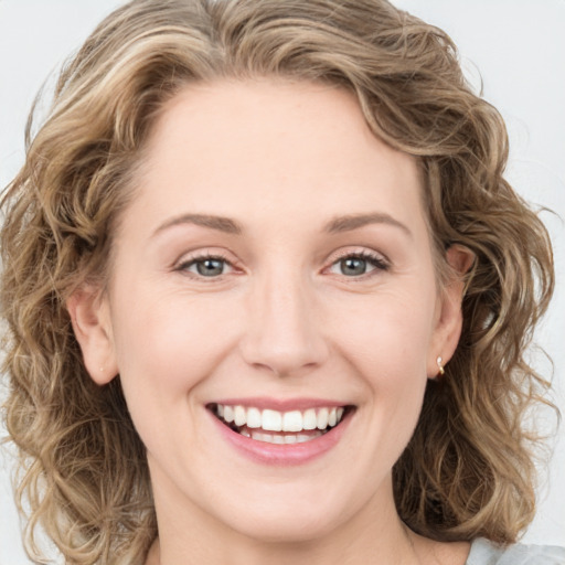 Joyful white young-adult female with long  brown hair and green eyes