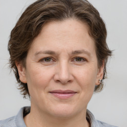 Joyful white adult female with medium  brown hair and grey eyes