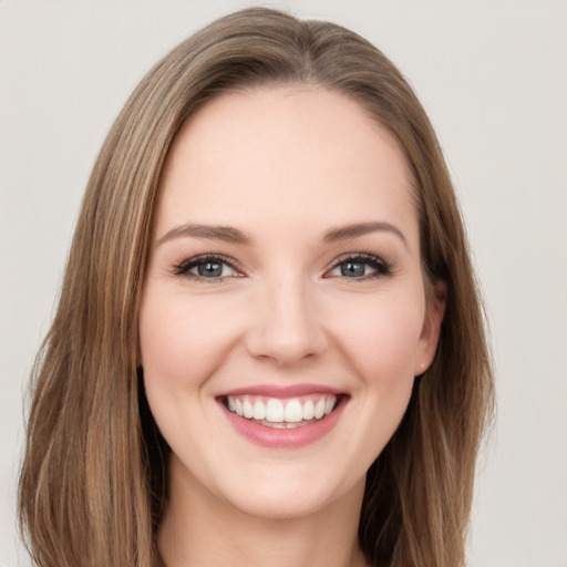 Joyful white young-adult female with long  brown hair and grey eyes