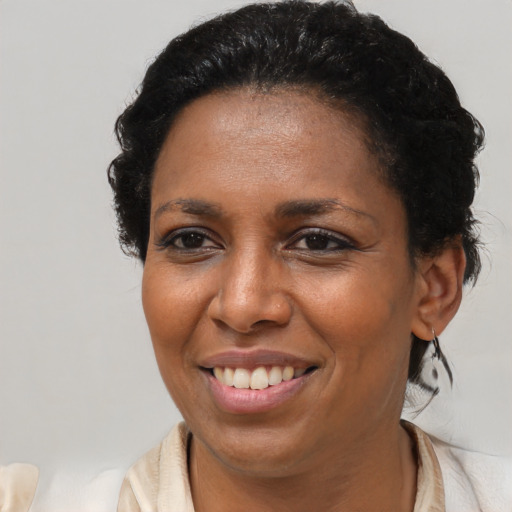 Joyful black young-adult female with medium  brown hair and brown eyes