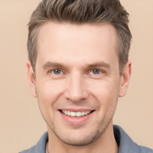 Joyful white adult male with short  brown hair and brown eyes