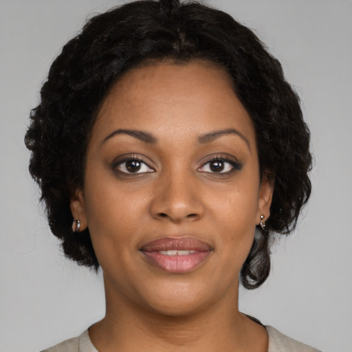 Joyful black young-adult female with medium  brown hair and brown eyes