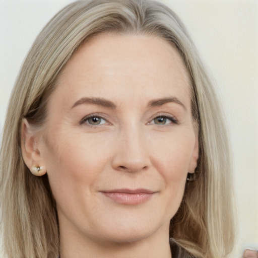 Joyful white adult female with long  brown hair and grey eyes