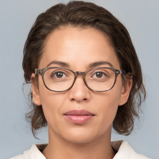 Joyful white adult female with medium  brown hair and brown eyes