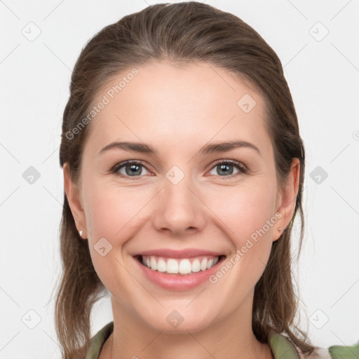 Joyful white young-adult female with medium  brown hair and grey eyes