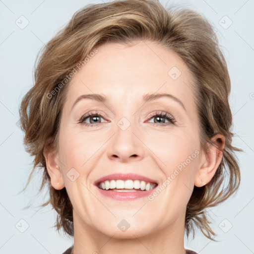 Joyful white adult female with medium  brown hair and blue eyes