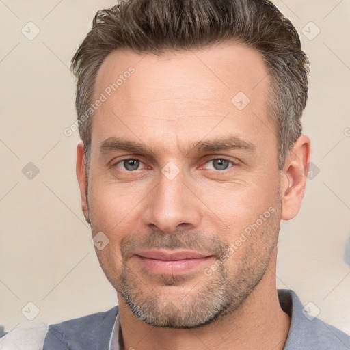 Joyful white adult male with short  brown hair and brown eyes