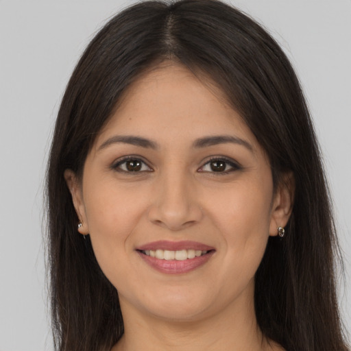 Joyful white young-adult female with long  brown hair and brown eyes