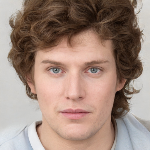 Joyful white young-adult male with medium  brown hair and blue eyes