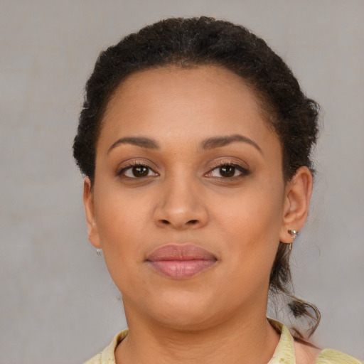 Joyful latino young-adult female with short  brown hair and brown eyes