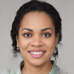 Joyful latino young-adult female with long  brown hair and brown eyes