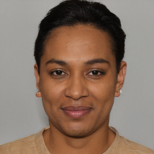 Joyful black young-adult female with short  black hair and brown eyes