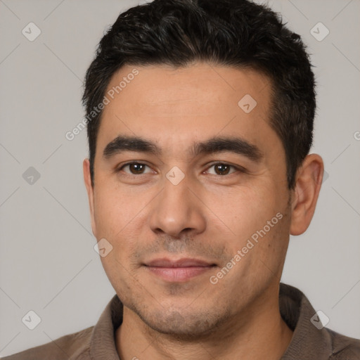 Joyful white young-adult male with short  black hair and brown eyes