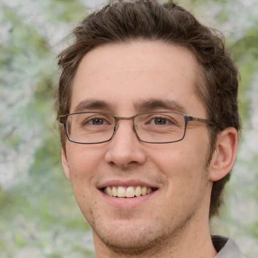 Joyful white adult male with short  brown hair and green eyes