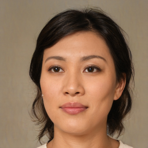 Joyful asian young-adult female with medium  black hair and brown eyes