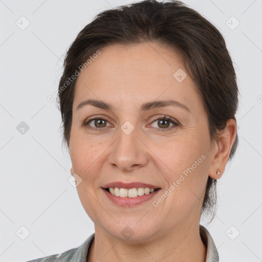 Joyful white adult female with medium  brown hair and brown eyes