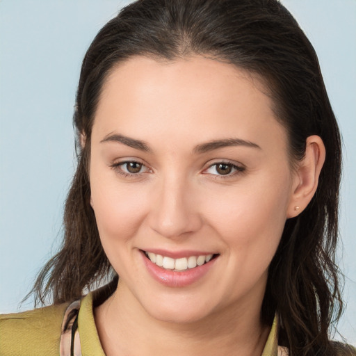 Joyful white young-adult female with long  brown hair and brown eyes