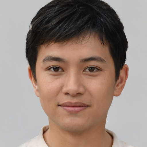 Joyful asian young-adult male with short  black hair and brown eyes