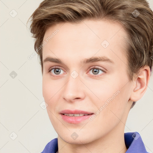 Joyful white young-adult female with short  brown hair and blue eyes