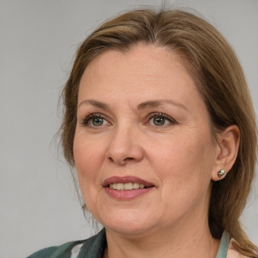 Joyful white adult female with medium  brown hair and blue eyes