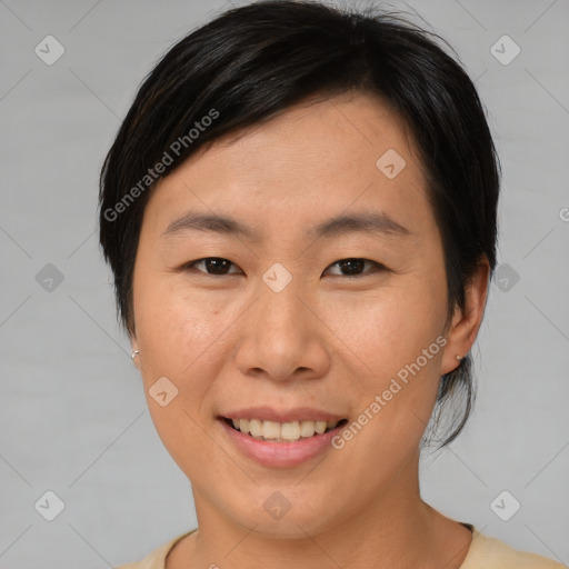 Joyful asian young-adult female with short  brown hair and brown eyes