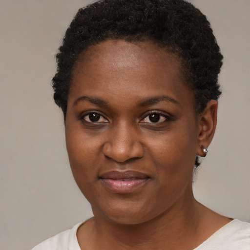 Joyful black young-adult female with short  black hair and brown eyes