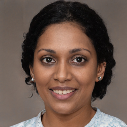 Joyful black young-adult female with medium  black hair and brown eyes