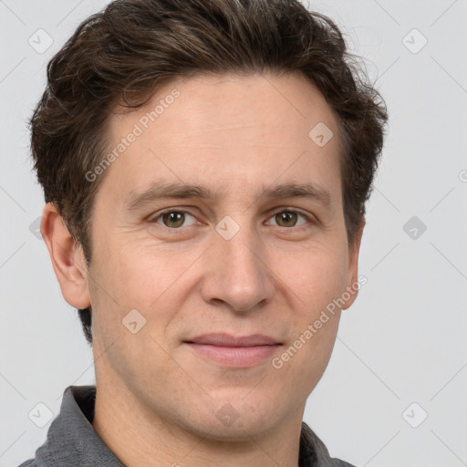 Joyful white adult male with short  brown hair and grey eyes