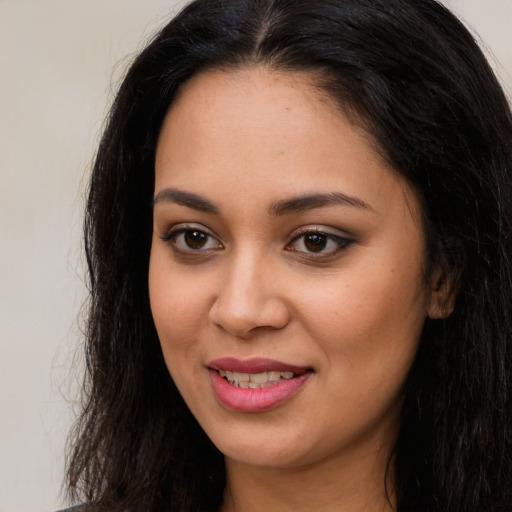 Joyful latino young-adult female with long  brown hair and brown eyes