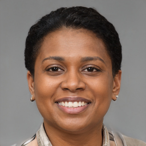 Joyful latino young-adult female with short  brown hair and brown eyes