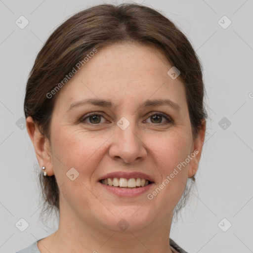 Joyful white adult female with medium  brown hair and grey eyes