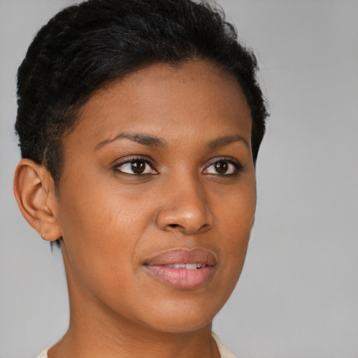 Joyful black young-adult female with short  brown hair and brown eyes