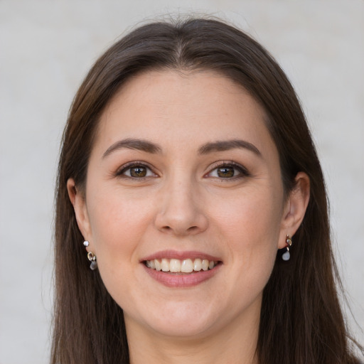 Joyful white young-adult female with long  brown hair and grey eyes