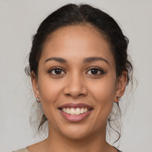 Joyful latino young-adult female with medium  brown hair and brown eyes