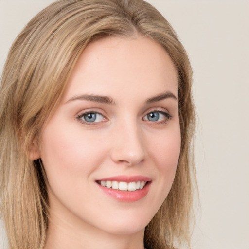 Joyful white young-adult female with long  brown hair and green eyes