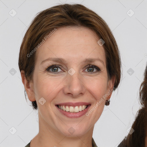 Joyful white adult female with medium  brown hair and grey eyes