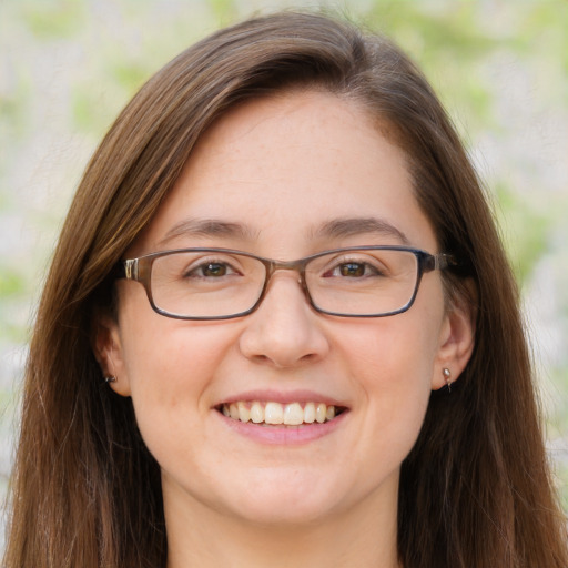 Joyful white adult female with long  brown hair and brown eyes