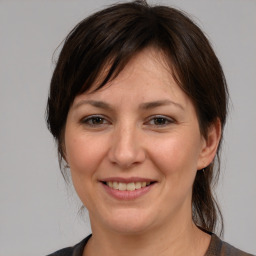 Joyful white adult female with medium  brown hair and brown eyes