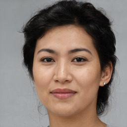 Joyful asian adult female with medium  brown hair and brown eyes