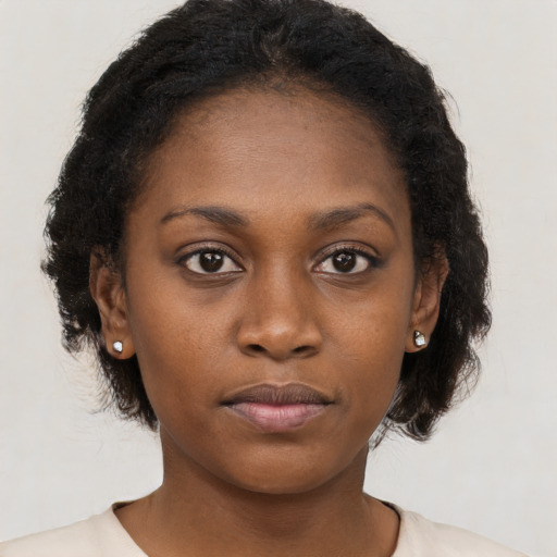 Neutral black young-adult female with long  brown hair and brown eyes