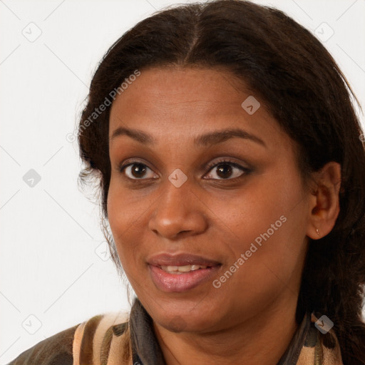 Joyful black young-adult female with long  brown hair and brown eyes