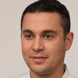 Joyful white adult male with short  brown hair and brown eyes