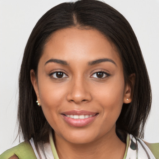 Joyful latino young-adult female with medium  brown hair and brown eyes