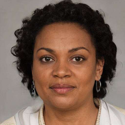 Joyful black adult female with short  brown hair and brown eyes