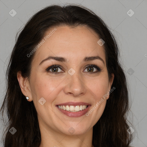 Joyful white adult female with long  brown hair and brown eyes