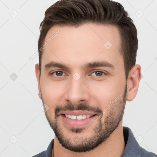 Joyful white young-adult male with short  brown hair and brown eyes