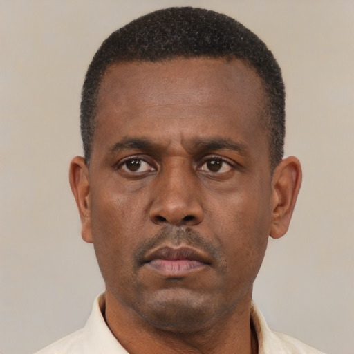 Neutral latino adult male with short  black hair and brown eyes